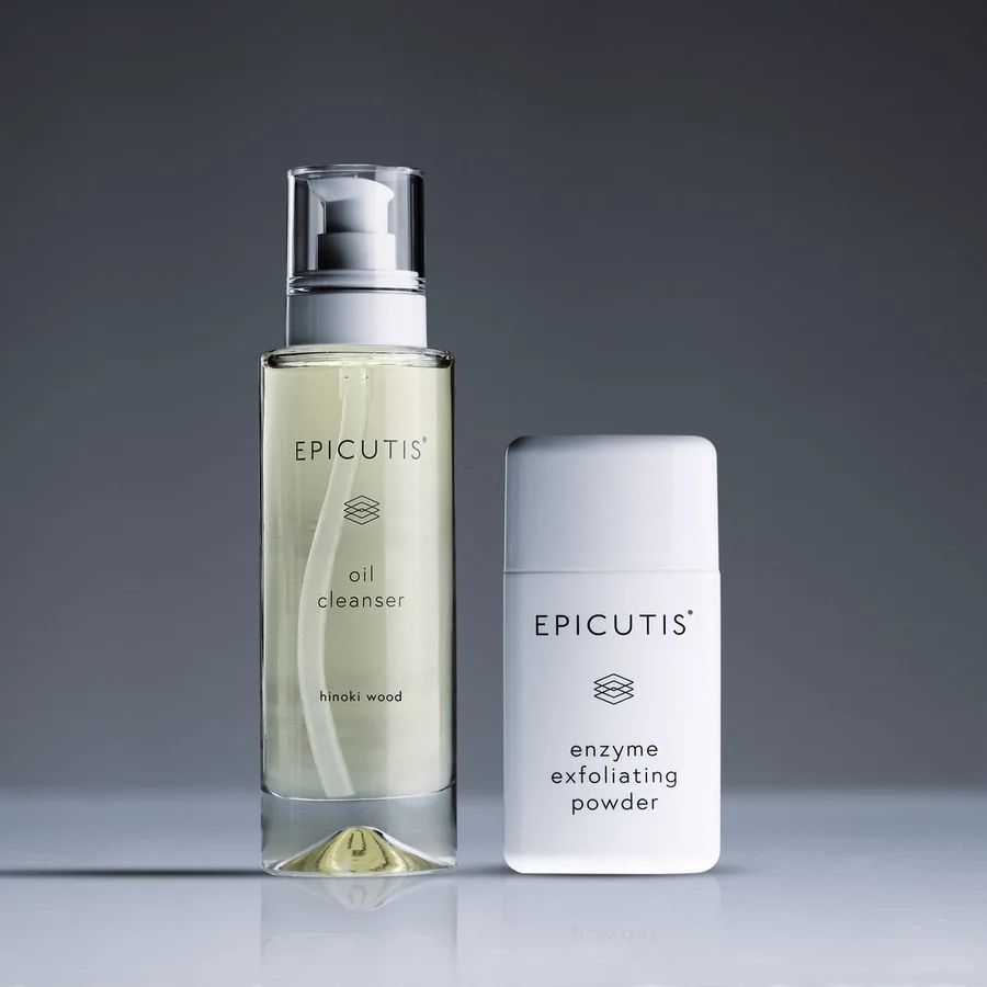 The Epicutis Cleansing Essentials Set, oil cleanser and exfoliating powder, on a charcoal ground.