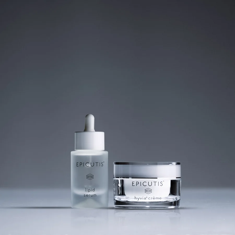 The Epicutis Luxury Skincare Set, serum and crème, on a charcoal ground.