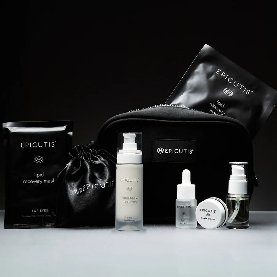 The Epicutis Luxury On-The-Go Care Set with its pouch, on a charcoal ground.