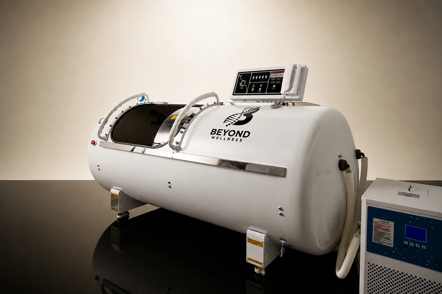 The single-person hardshell hyperbaric chamber, studio photograph on a warm ground.