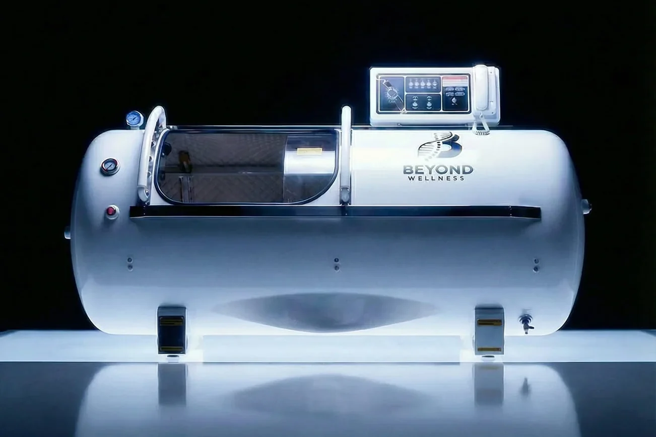 The lay-down hyperbaric chamber, photographed against a dark reflective ground.
