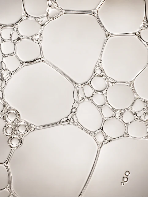 A close pattern of clear bubbles against a pale ground.